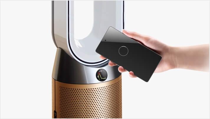 Mobile device being held close to the Dyson Pure Cool Cryptomic purifying fan